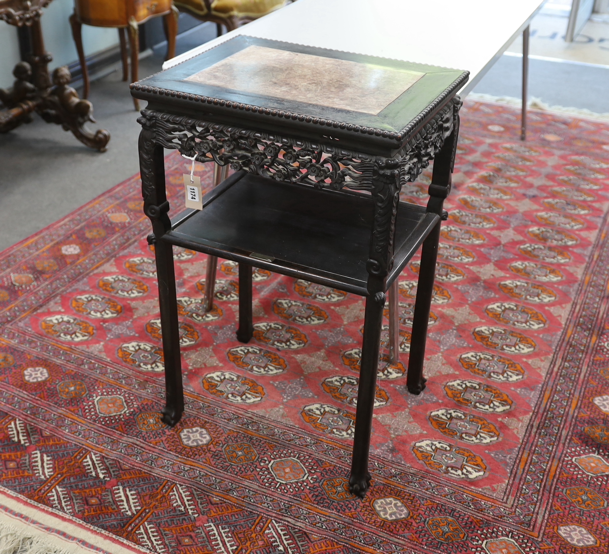 A Chinese carved hardwood marble topped rectangular two tier table, width 51cm, depth 40cm, height 80cm
